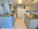 Kitchen featuring light blue cabinets, granite counters, and white appliances at 1055 S Hiawassee Rd # 2018, Orlando, FL 32835