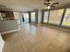 Bright living room with beige tile flooring, ceiling fan and sliding door access to the balcony at 1055 S Hiawassee Rd # 2018, Orlando, FL 32835