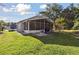 Home exterior view of backyard, enclosed patio, outdoor seating area, and green grass at 1118 Brielle Ct, Oviedo, FL 32765