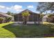 Spacious backyard with green grass, enclosed patio, and outdoor seating area at 1118 Brielle Ct, Oviedo, FL 32765