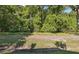 Green backyard featuring mature trees, bushes and plants and a large grass area at 1118 Brielle Ct, Oviedo, FL 32765