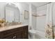Neutral bathroom featuring vanity with marble counter top, updated fixtures, and tub with shower at 1118 Brielle Ct, Oviedo, FL 32765