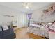Bedroom featuring wood laminate floors, closet, purple accents, and ample space at 1118 Brielle Ct, Oviedo, FL 32765