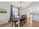 Charming dining area with wood table, modern lighting, and view to the kitchen at 1118 Brielle Ct, Oviedo, FL 32765