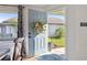 Open foyer with a stylish door, modern decor, and a glimpse of the sunny outdoors at 1118 Brielle Ct, Oviedo, FL 32765