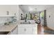 Open kitchen boasts granite counters, stainless sink, and breakfast bar overlooking the dining area at 1118 Brielle Ct, Oviedo, FL 32765