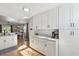 Well-lit kitchen includes white cabinets, granite countertops, and stainless appliances at 1118 Brielle Ct, Oviedo, FL 32765