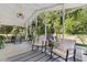 Relaxing screened-in lanai with comfortable seating, string lights, and views of the serene backyard at 1118 Brielle Ct, Oviedo, FL 32765