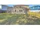 Expansive backyard showcasing the home's exterior, a large lawn, and a screened-in pool area with a spa at 1176 Liberty Hall Dr, Kissimmee, FL 34746