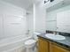 Cozy bathroom with a shower and bathtub, flowers, and a vanity with sink at 1176 Liberty Hall Dr, Kissimmee, FL 34746