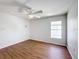 Clean bedroom featuring hardwood floors, ceiling fan, and natural light at 1176 Liberty Hall Dr, Kissimmee, FL 34746