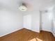 Bright bedroom with wood floors, neutral walls, ceiling fan, closet, and white doors at 1176 Liberty Hall Dr, Kissimmee, FL 34746