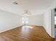 Sunlit bedroom boasts wood-look floors and a door leading to additional rooms at 1176 Liberty Hall Dr, Kissimmee, FL 34746