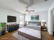 Staged bedroom with ceiling fan, hardwood floors, and a large window at 1176 Liberty Hall Dr, Kissimmee, FL 34746