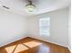 Bright bedroom with wood floors, neutral walls, a ceiling fan, and a window with a view at 1176 Liberty Hall Dr, Kissimmee, FL 34746