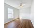 Bright bedroom featuring hardwood floors, ceiling fan, and a window providing natural light at 1176 Liberty Hall Dr, Kissimmee, FL 34746