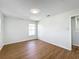 Bright bedroom with wood-look floors, window, and neutral paint, providing a calm, inviting space at 1176 Liberty Hall Dr, Kissimmee, FL 34746