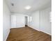 Large bedroom with wood-look floors, large closet, and natural light from adjacent windows at 1176 Liberty Hall Dr, Kissimmee, FL 34746