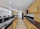 Spacious kitchen with wood cabinets, granite countertops, stainless sink, and matching appliances at 1176 Liberty Hall Dr, Kissimmee, FL 34746