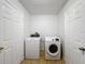 Functional laundry room with washer, dryer, and convenient access to the hall and garage at 1176 Liberty Hall Dr, Kissimmee, FL 34746