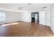 Spacious living room featuring wood-look floors and double doors, perfect for relaxation at 1176 Liberty Hall Dr, Kissimmee, FL 34746