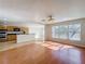 Inviting living area with hardwood floors, connecting to a kitchen with stainless steel appliances at 1176 Liberty Hall Dr, Kissimmee, FL 34746