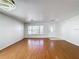 Spacious living room featuring hardwood floors and large window offering natural light at 1176 Liberty Hall Dr, Kissimmee, FL 34746