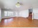 Spacious living room with hardwood floors, front door, and staircase access at 1176 Liberty Hall Dr, Kissimmee, FL 34746