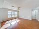 A bright living room with hardwood floors and lots of natural light from the windows at 1176 Liberty Hall Dr, Kissimmee, FL 34746