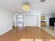 Spacious living room with wood floors and an open layout leading to other rooms at 1176 Liberty Hall Dr, Kissimmee, FL 34746