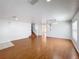 Open living room with hardwood floors, recessed lighting and an adjacent staircase at 1176 Liberty Hall Dr, Kissimmee, FL 34746