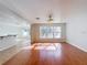 Open-concept living space with hardwood flooring and view to dining area at 1176 Liberty Hall Dr, Kissimmee, FL 34746