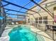 Enclosed pool area with a well-maintained pool, outdoor seating, and a -safe fence ensuring secure Gathering fun at 1176 Liberty Hall Dr, Kissimmee, FL 34746