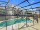 Private screened-in pool and spa offering a relaxing backyard oasis at 1176 Liberty Hall Dr, Kissimmee, FL 34746