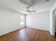 A spacious room featuring hardwood floors, a ceiling fan, and natural light at 1176 Liberty Hall Dr, Kissimmee, FL 34746