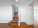 Hardwood staircase with white walls and trim provides a seamless transition to the upper level at 1176 Liberty Hall Dr, Kissimmee, FL 34746