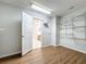 Spacious walk-in closet with wire shelving, wood-look flooring, and access to the bathroom at 1176 Liberty Hall Dr, Kissimmee, FL 34746