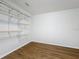 Spacious walk-in closet with built-in shelving and wood-look flooring at 1176 Liberty Hall Dr, Kissimmee, FL 34746