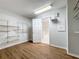 Walk-in closet with wood-look flooring, wire shelving and access to the bathroom at 1176 Liberty Hall Dr, Kissimmee, FL 34746