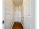 Narrow walk-in closet with wire shelving on both sides and wood-look flooring at 1176 Liberty Hall Dr, Kissimmee, FL 34746