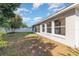 Spacious backyard featuring a glimpse of the screened-in lanai with large windows at 12213 Bohannon Blvd, Orlando, FL 32824