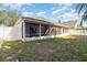 Backyard featuring the screened patio and a fenced-in yard for privacy at 12213 Bohannon Blvd, Orlando, FL 32824