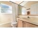 Well-lit bathroom featuring a shower-tub combo and a single sink vanity at 12213 Bohannon Blvd, Orlando, FL 32824