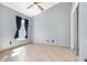 Bedroom features neutral paint, tile flooring, and a window with dark curtains at 12213 Bohannon Blvd, Orlando, FL 32824