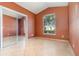 Bedroom features a window, closet with mirrored doors, and tile flooring at 12213 Bohannon Blvd, Orlando, FL 32824