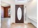 View of the foyer with tile flooring, shelving, and a decorative oval-windowed door at 12213 Bohannon Blvd, Orlando, FL 32824