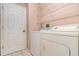 Convenient laundry room with washer, dryer, and shelving for storage at 12213 Bohannon Blvd, Orlando, FL 32824