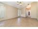 Living room with neutral walls, tile floors, a ceiling fan, and entry to other rooms at 12213 Bohannon Blvd, Orlando, FL 32824