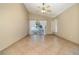 Open living room featuring tile floors, a ceiling fan, and sliding glass doors to the outdoor area at 12213 Bohannon Blvd, Orlando, FL 32824