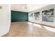 Open living room featuring tile floors, a ceiling fan, and three large windows at 12213 Bohannon Blvd, Orlando, FL 32824